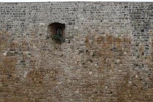 Stone wall of an ancient fortress on the seashore in Israel. photo