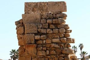Stone wall of an ancient fortress on the seashore in Israel. photo