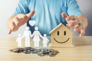 man protect on the piggybank and icon family on table, superannuation, investment, fundraising, charity, donation, saving, family finance plan concept, Money Saving Ideas for Buying a Home. photo