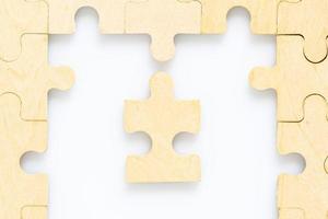 wooden jigsaw puzzle pieces on white background photo