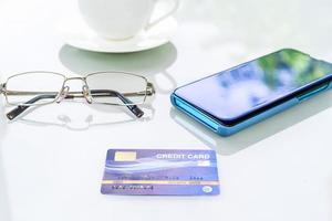 Smartphone with credit card on deck photo