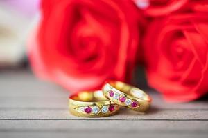 Close up wedding ring and red rose photo
