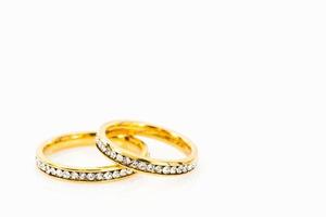 Gold wedding rings on white background photo