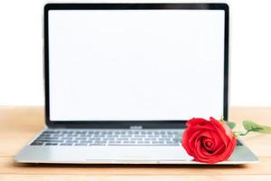 Red rose and laptop mockup on white photo