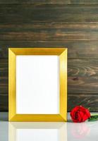 Picture mock up with golden frame on table with copy space photo