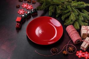 Christmas table with empty plate and surface with New Year's decorations photo