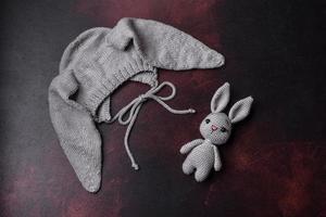 Cute knitted gray hat with ears for a small baby photo