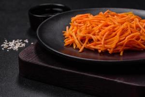 Tasty spicy Korean carrot with spices and herbs photo