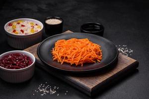 Tasty spicy Korean carrot with spices and herbs photo