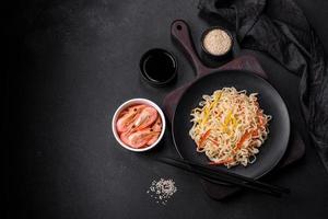 Delicious fresh rice noodles with shrimp, spices and herbs photo