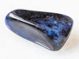 polished dumortierite gem on white photo