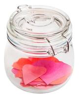 many hearts cut from paper in closed glass jar photo