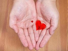 little and big hearts on male palms photo