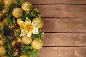 Shiny yellow Christmas balls and cone with barks and pine branch