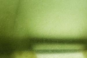Brushed green metallic wall with scratched surface, abstract texture background photo