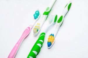 Various toothbrushes on a white background photo