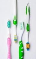 Various toothbrushes on a white background photo