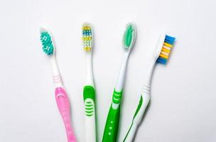 Various toothbrushes on a white background photo