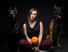 Portrait of a Doberman dog and a Belgian shepherd dog with a girl owner. photo