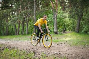 Portrait of a young man moving on a Bicycle. photo