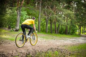 Portrait of a young man moving on a Bicycle. photo