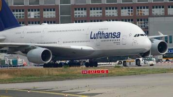 FRANKFURT AM MAIN, GERMANY JULY 17, 2017 - The tractor tows Lufthansa Airbus 380 D AIMH named  New York  to service. Fraport, Frankfurt, Germany video