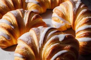 croissants with icing in modern bakery photo