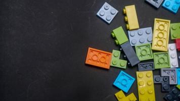 Plastic toy block on a black background photo