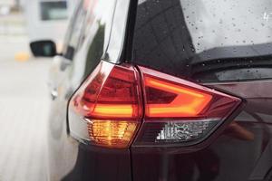 Rear particle view of modern black automobile. Close up view of headlights photo