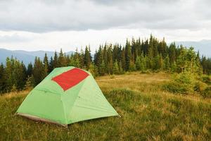 Red flag on the tent. Majestic Carpathian Mountains. Beautiful landscape of untouched nature photo