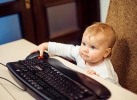 Little child with keyboard photo