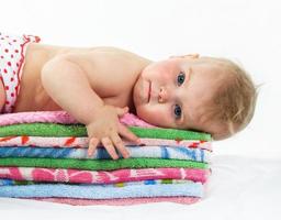 baby is on colourful towels photo
