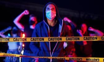 In protective masks. Group of protesting young people that standing together. Activist for human rights or against government photo