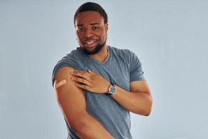 Young african american man after vaccine injection is indoors photo