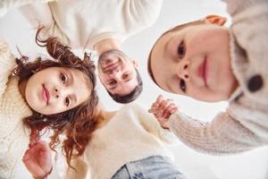 View from below. Happy family looking down and having fun photo