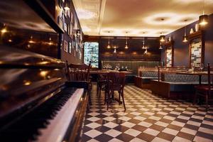 Interior of modern cafe where is no people. Artificial lighting photo