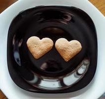 Pile of cookies on a black plate photo