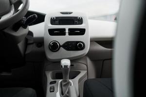 Inside of brand new modern electrical car. Particle view. Cropped photo