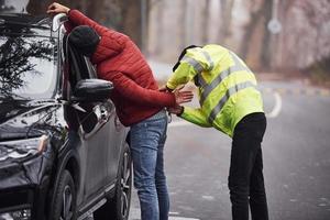 Police officer in green uniform caught automobile theft on the road photo