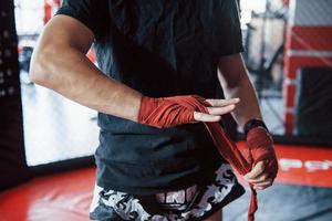 Preparation before the training. Close up shot of young boxer photo