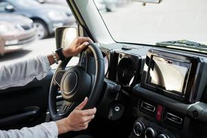 Particle view of woman that drives modern new car in the city photo