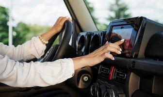 Control panel. Particle view of woman that drives modern new car in the city photo