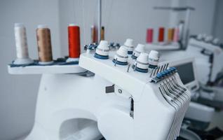 vista de cerca de la máquina de coser automática blanca en la fábrica foto