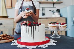 Close up view of woman that makes sweets in the kitchen photo