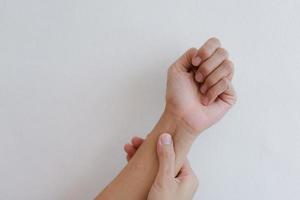 Closeup of hand with hand pain in palm isolated on gray wall background. photo