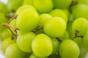 Close up green grape on white background photo