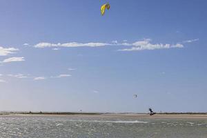 Picture of kitesurfers in stormy weather and sunshine in Florida photo