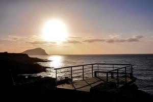 View with pier on the beach photo