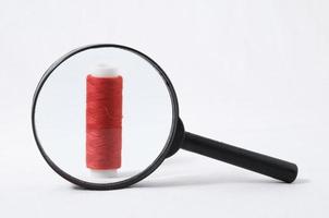 Magnifier and thread spool photo