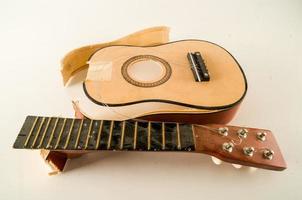 Broken acoustic guitar photo